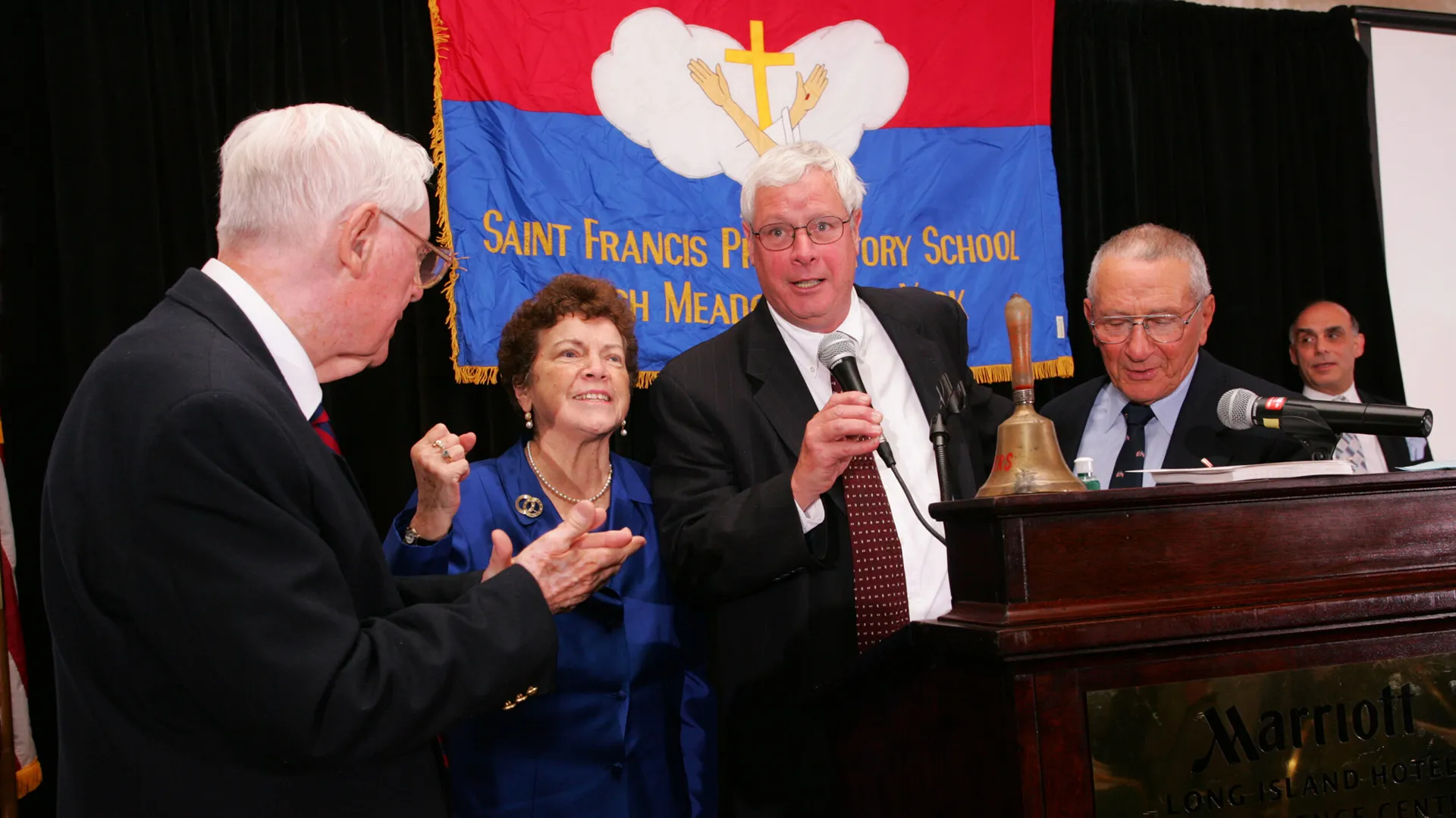 School and alumni leaders speaking at a formal event hosted by St. Francis Preparatory School