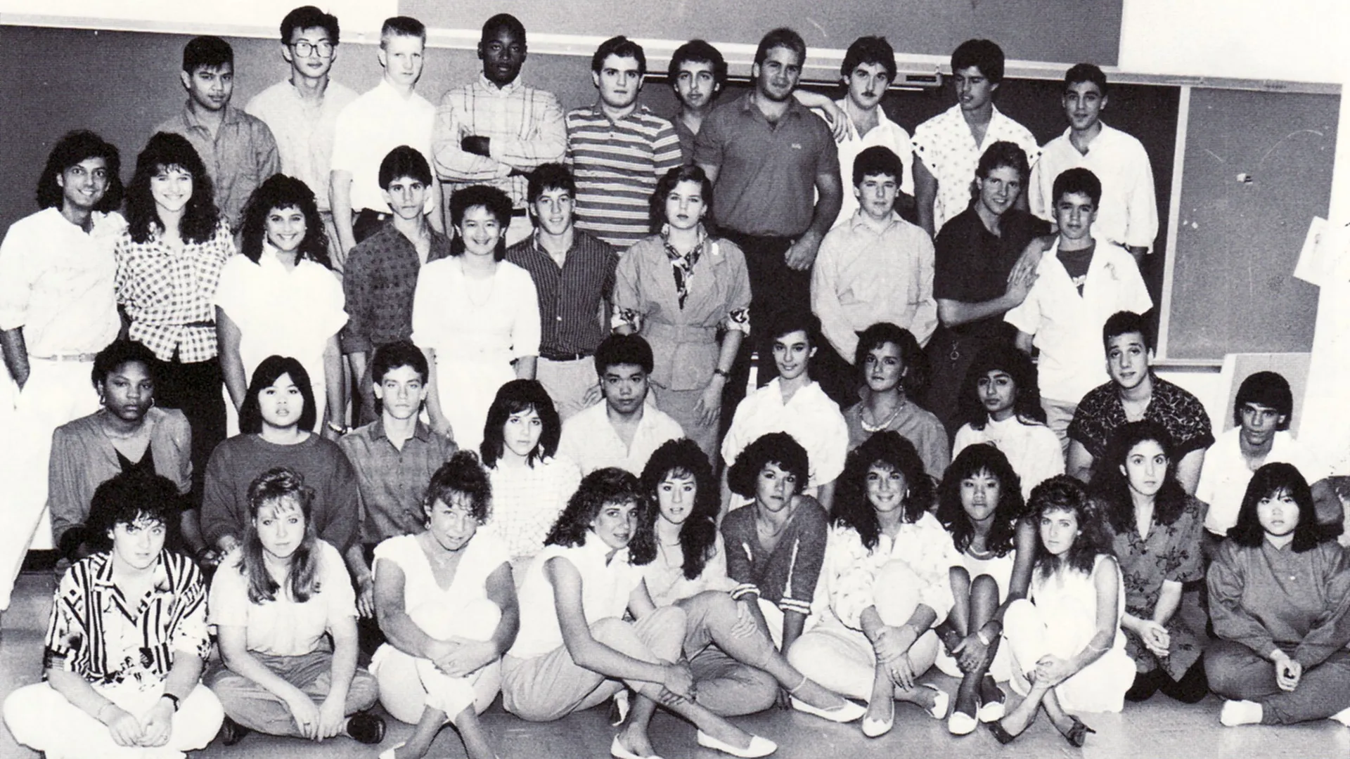 Black-and-white group photo of students posed in several rows inside a classroom, appearing to be a vintage high school class photograph.